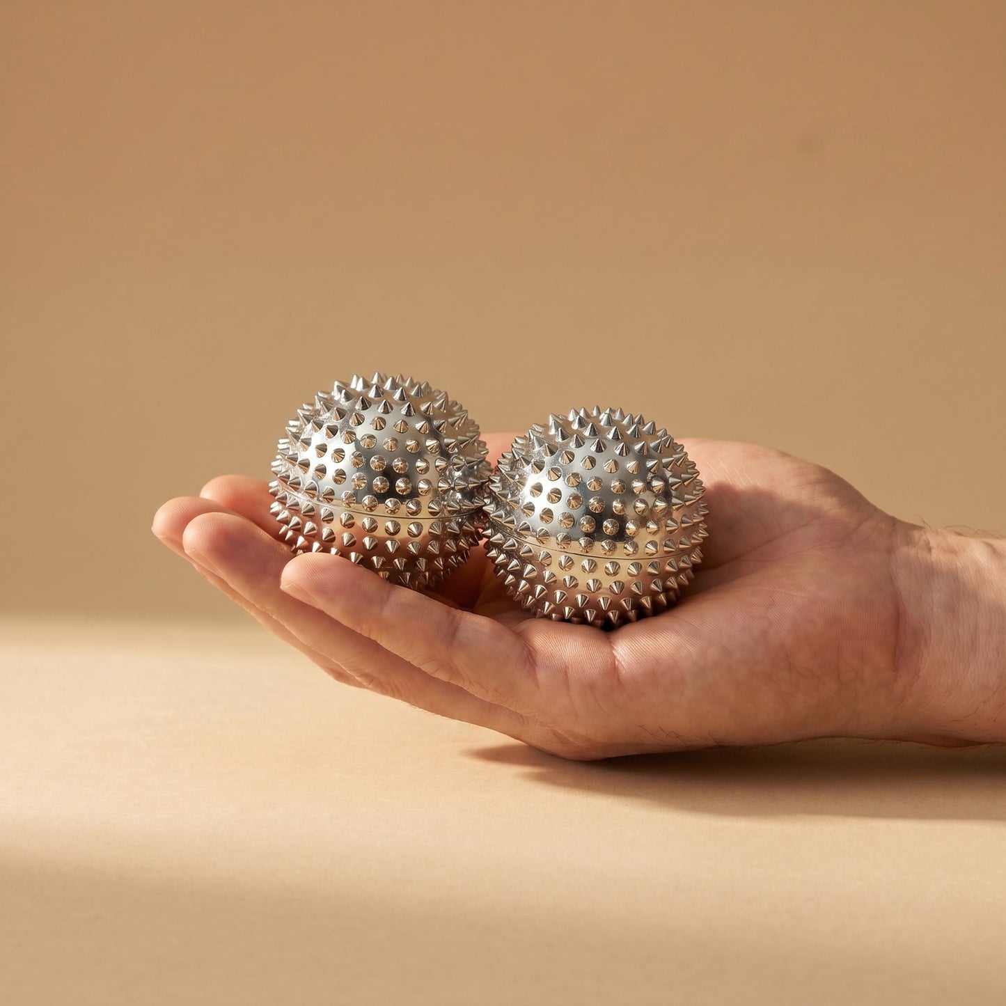 Restora Acupressure Massage Ball — silver, in hand