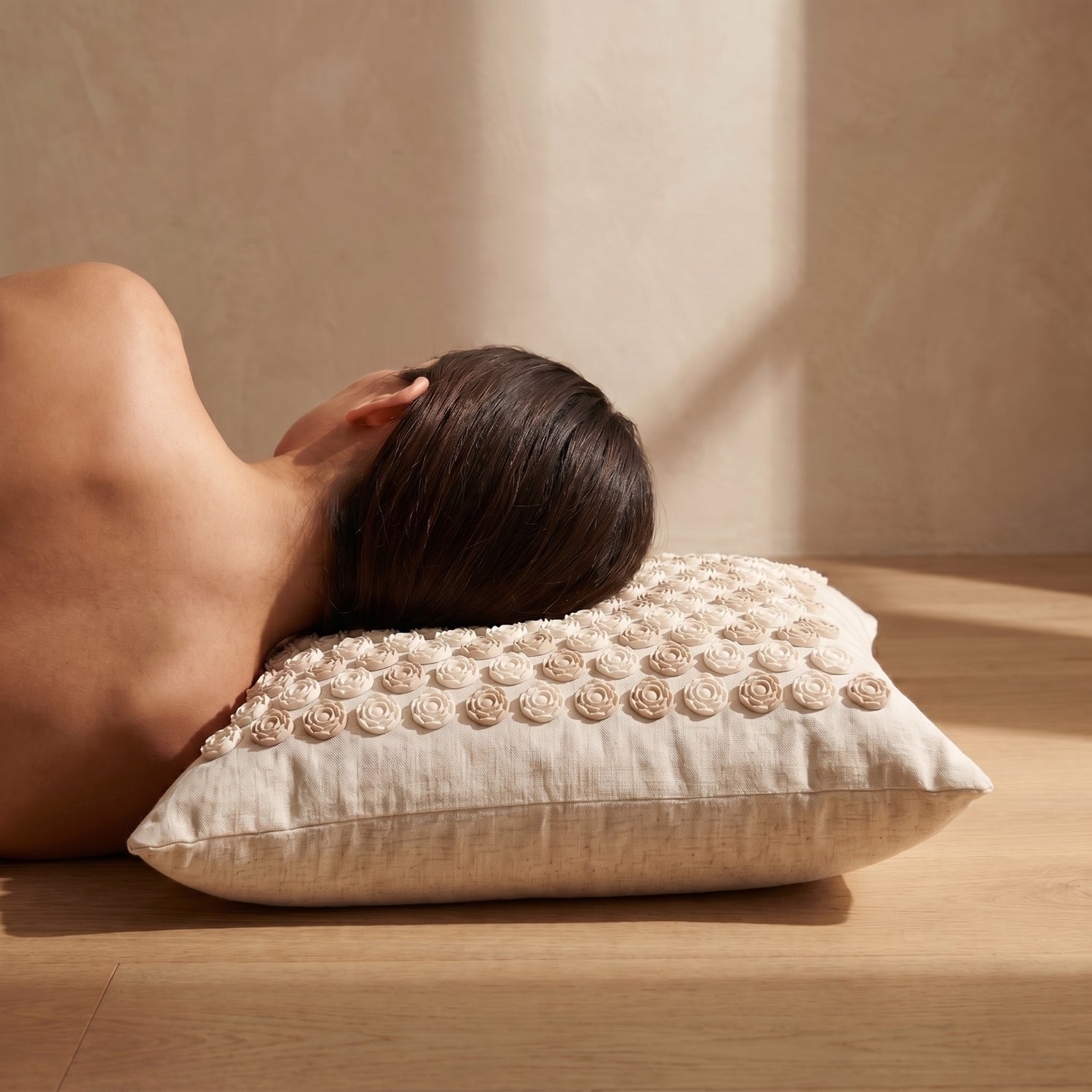 Head resting back on the Restora premium acupressure pillow — shoulders drop